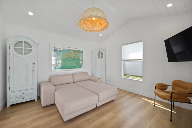 living room featuring vaulted ceiling, light hardwood / wood-style flooring, and wood ceiling