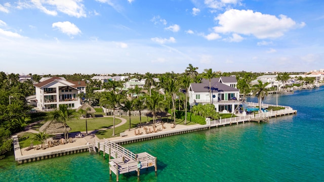 exterior space featuring a patio area, a yard, a water view, and a balcony