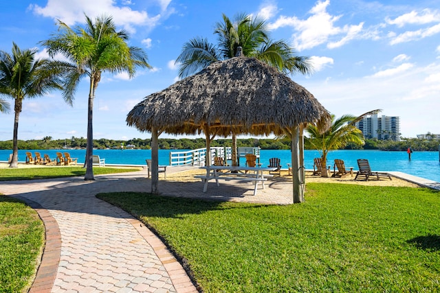 view of community with a gazebo, a water view, and a lawn