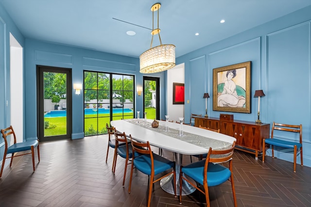 dining space featuring dark parquet flooring