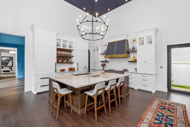 dining space with a high ceiling, dark hardwood / wood-style flooring, and sink