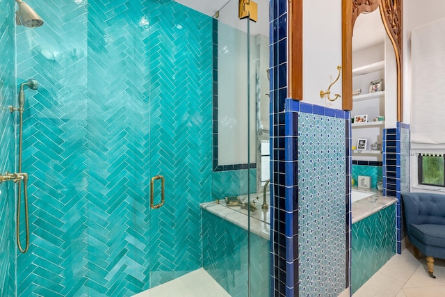 bathroom with a shower with door, tile walls, backsplash, and tile patterned flooring