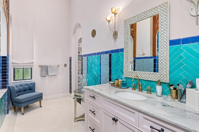 bathroom featuring tile patterned floors, tile walls, and vanity