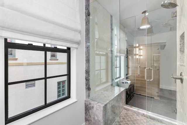 bathroom featuring a healthy amount of sunlight, walk in shower, and tile patterned floors