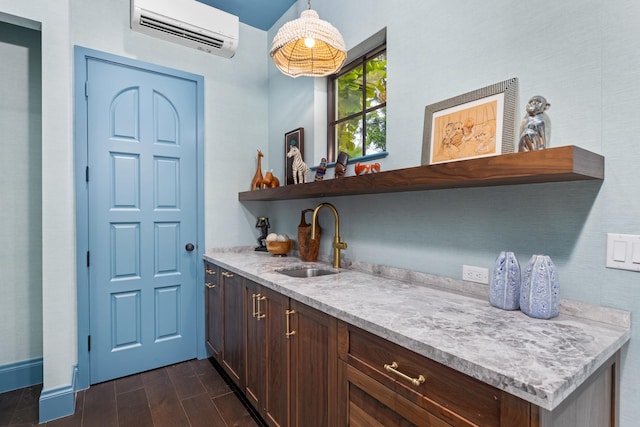 bar with a wall mounted air conditioner, dark brown cabinets, decorative light fixtures, sink, and dark wood-type flooring