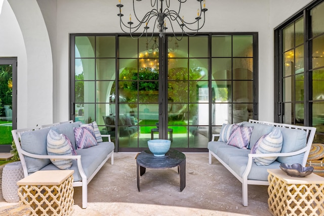 sunroom / solarium with a notable chandelier