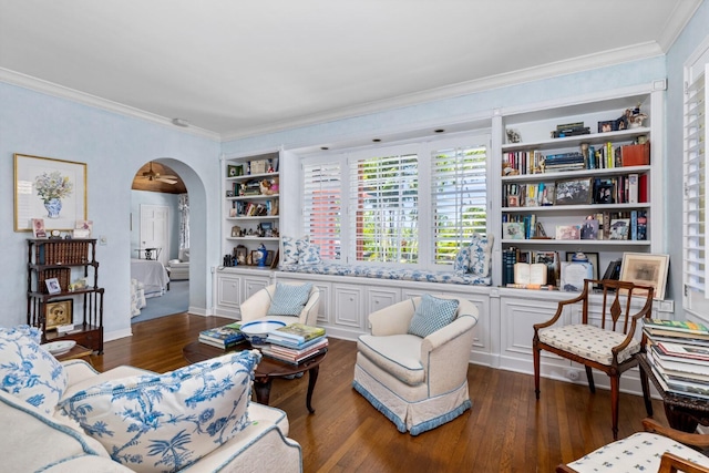 sitting room featuring dark hardwood / wood-style flooring, built in features, and ornamental molding