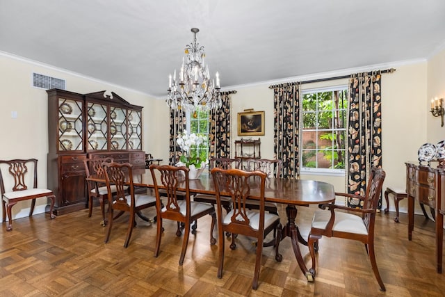 dining area with dark parquet floors, an inviting chandelier, and crown molding