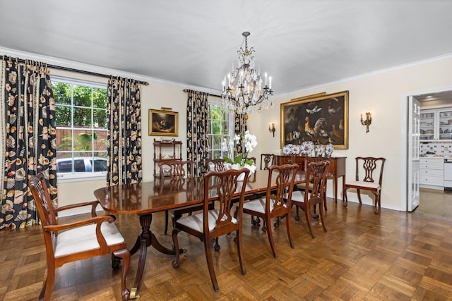 dining room featuring ornamental molding, dark parquet floors, a healthy amount of sunlight, and a notable chandelier