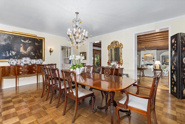 dining space with parquet floors, crown molding, and a chandelier