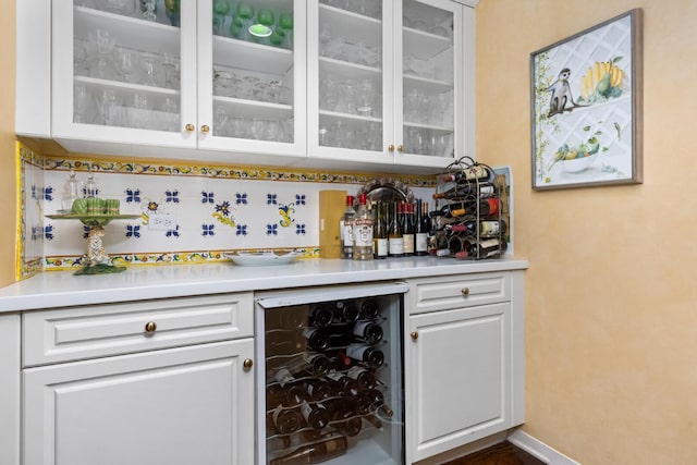 bar with white cabinets and wine cooler