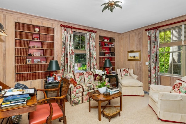 sitting room featuring wooden walls, built in features, and carpet floors