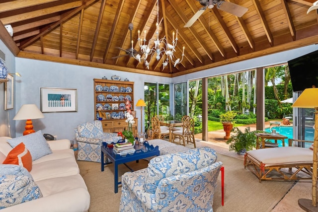 living room with lofted ceiling with beams, wooden ceiling, and ceiling fan with notable chandelier