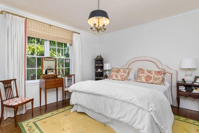 bedroom with dark wood-type flooring, a chandelier, and ornamental molding