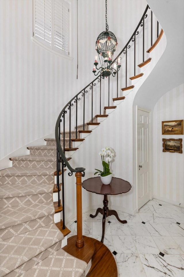 staircase featuring a towering ceiling