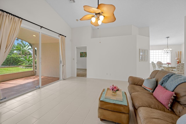 tiled living room featuring lofted ceiling, ceiling fan, and a wealth of natural light