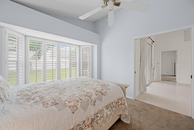 carpeted bedroom featuring lofted ceiling and ceiling fan