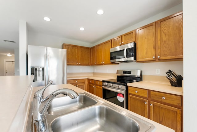 kitchen with sink and appliances with stainless steel finishes