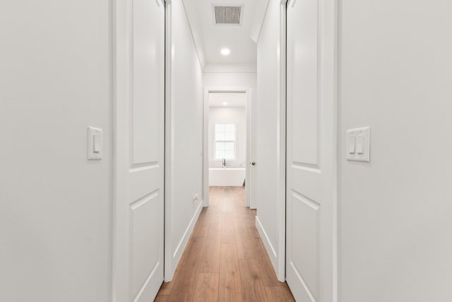 hall with hardwood / wood-style flooring