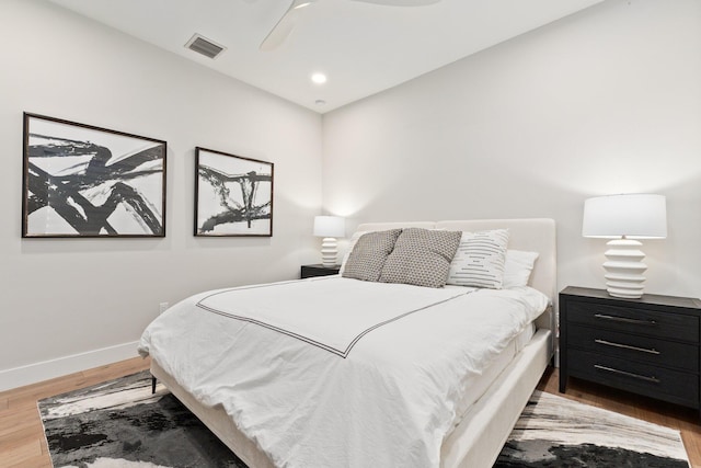 bedroom with ceiling fan and wood-type flooring