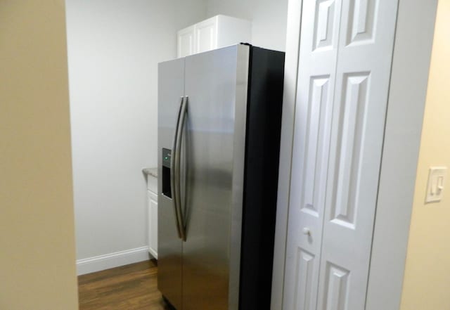 kitchen featuring dark hardwood / wood-style flooring, white cabinetry, and stainless steel refrigerator with ice dispenser