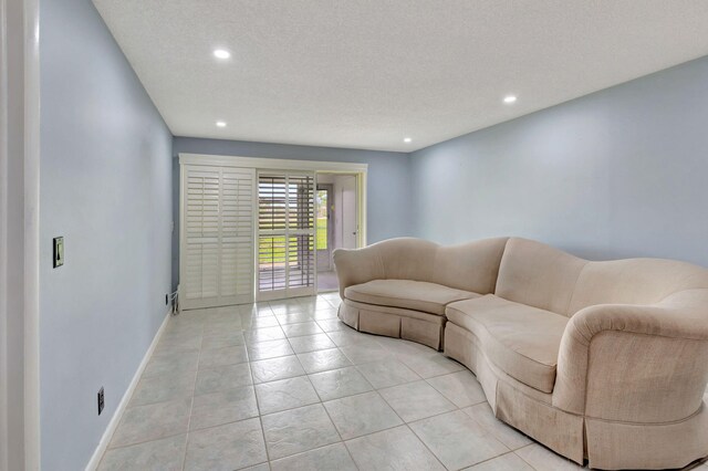 living room with light tile patterned floors and a textured ceiling