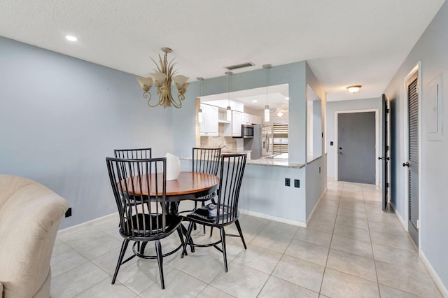 tiled dining room with a textured ceiling