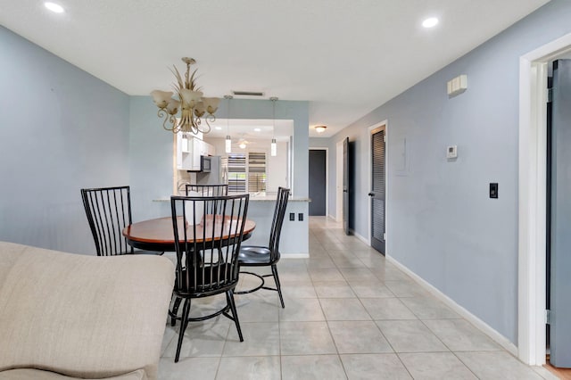 dining room with a notable chandelier and light tile patterned floors