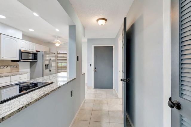 kitchen featuring white cabinets, appliances with stainless steel finishes, light tile patterned flooring, ceiling fan, and a textured ceiling