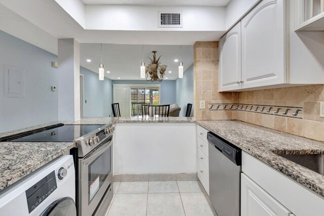 kitchen featuring stainless steel appliances, light stone counters, light tile patterned floors, and white cabinetry