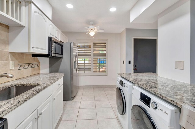 kitchen with white cabinets, light stone countertops, sink, and ceiling fan