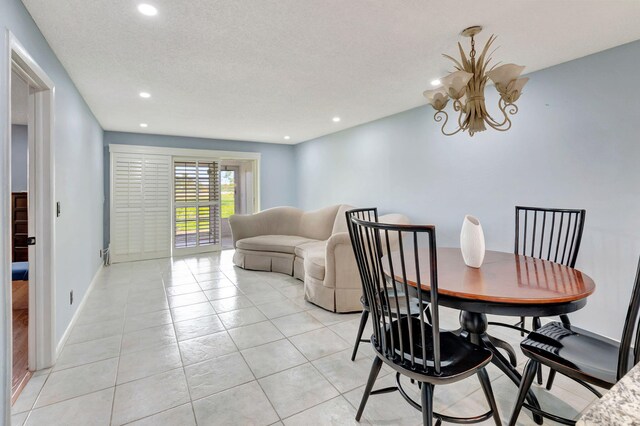 tiled dining room with a textured ceiling