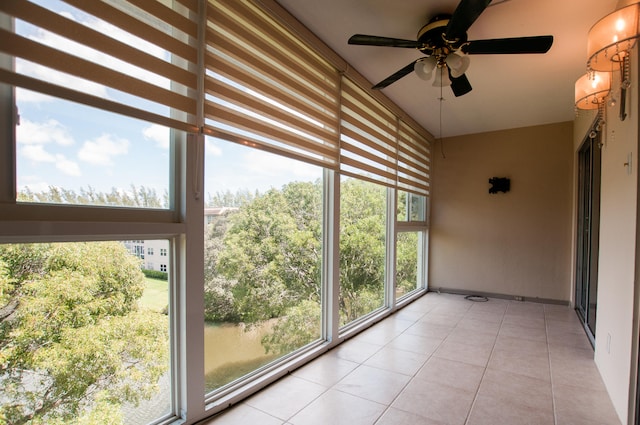 unfurnished sunroom with ceiling fan