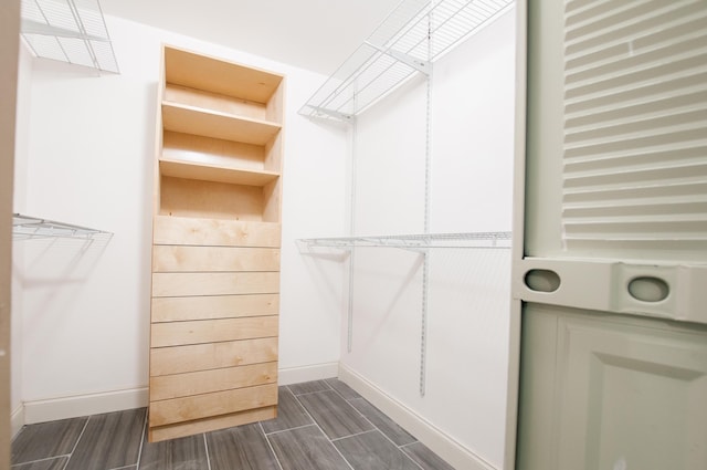 walk in closet with wood tiled floor