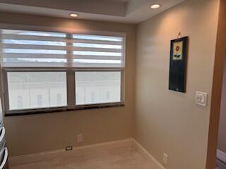 unfurnished room with recessed lighting and baseboards