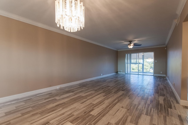 empty room featuring crown molding, ceiling fan with notable chandelier, and hardwood / wood-style floors