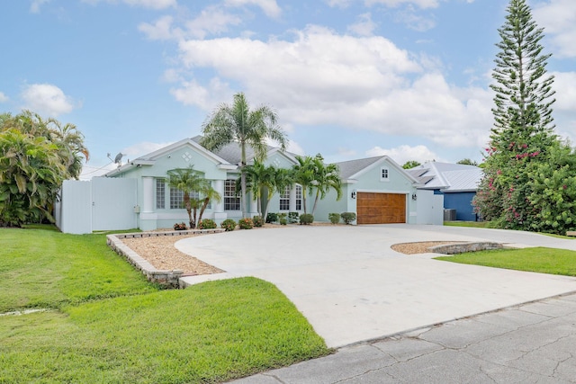 single story home with a garage and a front lawn