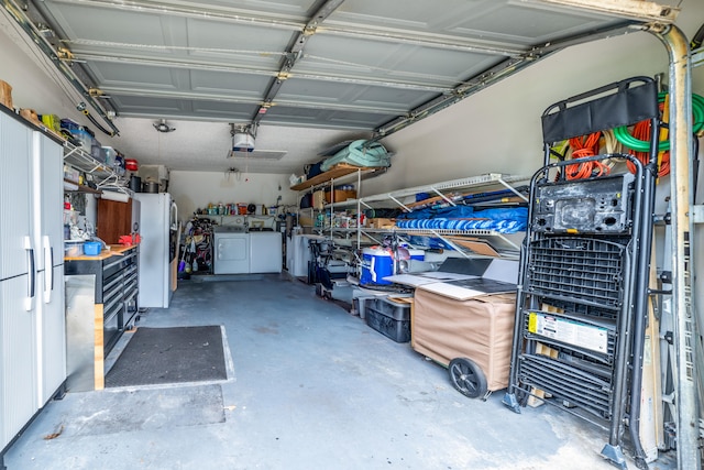 garage featuring washer and dryer and white fridge