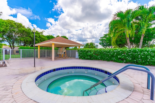 view of pool featuring a patio, a gazebo, and a hot tub