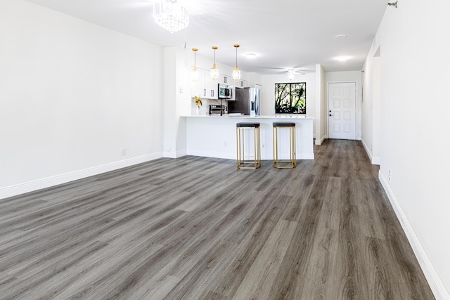 interior space with ceiling fan and dark wood-type flooring