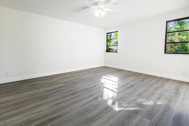 spare room featuring ceiling fan and dark wood-type flooring