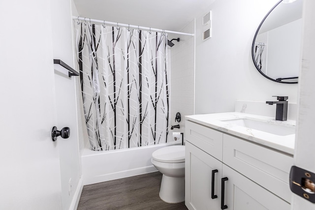 full bathroom with shower / tub combo with curtain, hardwood / wood-style floors, vanity, and toilet