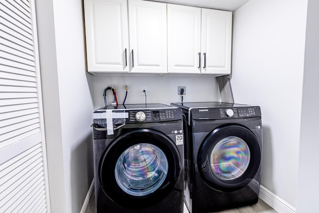 laundry room with cabinets and separate washer and dryer