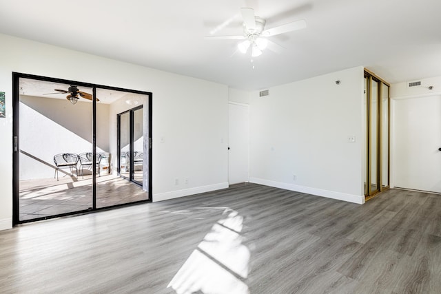 empty room featuring hardwood / wood-style floors and ceiling fan