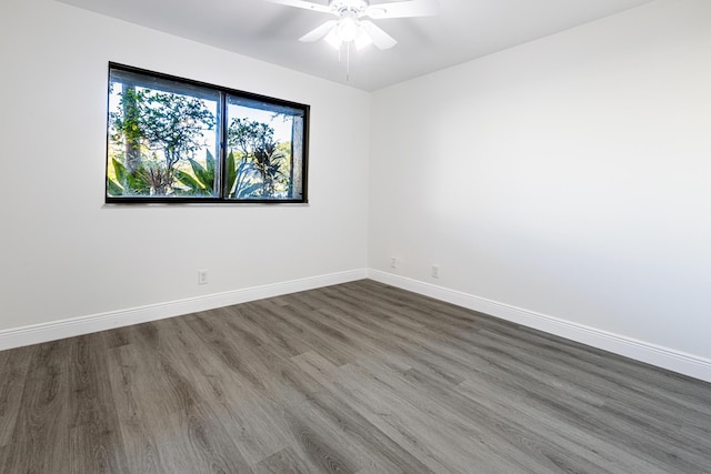 unfurnished room featuring ceiling fan and dark hardwood / wood-style flooring