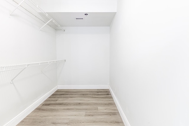 walk in closet featuring wood-type flooring