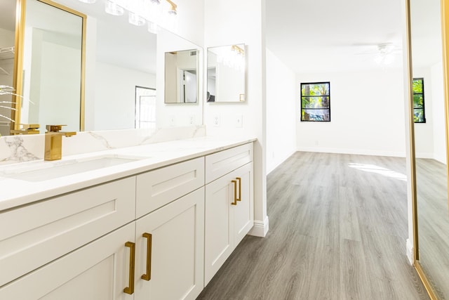 bathroom with vanity, hardwood / wood-style floors, and ceiling fan