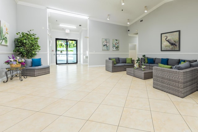 living room with ornamental molding and light tile patterned floors