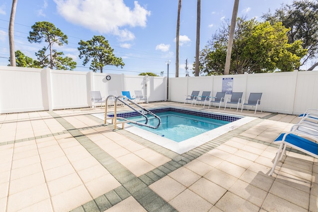 view of swimming pool with a patio