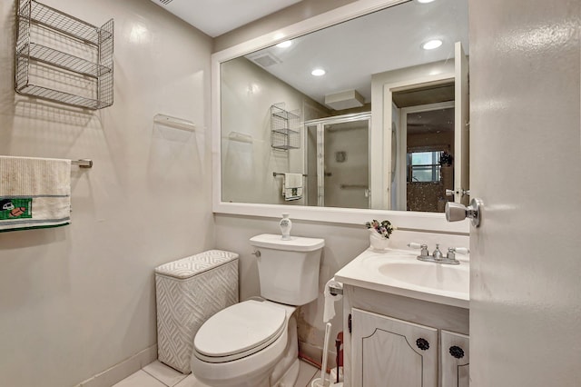 bathroom with vanity, toilet, walk in shower, and tile patterned floors